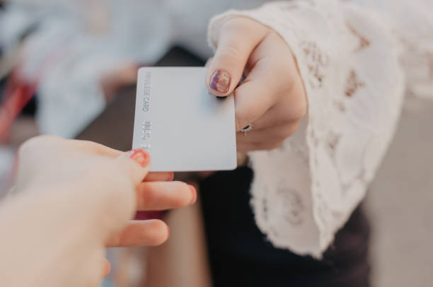 Giving credit card while buying stock photo