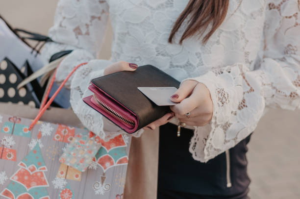 Woman holding shopping bags, wallet and credit card stock photo