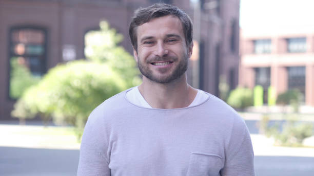 istock Portrait of Smiling Handsome Man Looking at Camera 1038171584