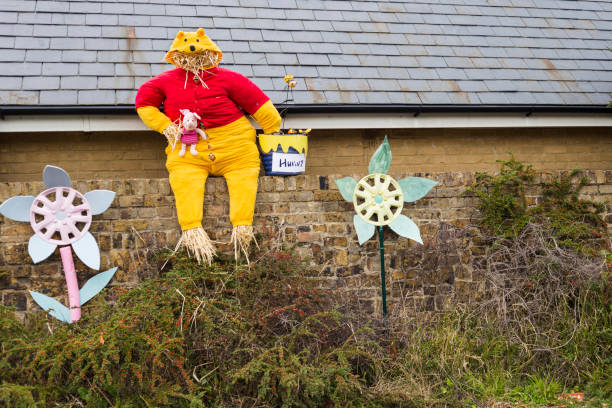 Scarecrow figure Pooh bear High Wych, Essex, UK - SEPTEMBER 8, 2018: Scarecrow traditional festival taking inspiration from all theme of our contemporary life. winnie the pooh photos stock pictures, royalty-free photos & images