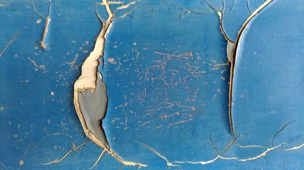 Old car paint damaged by rusted steel.