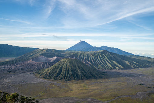 Picture of Bromo mountains view in the morning with sand desert and smoke from active crater
