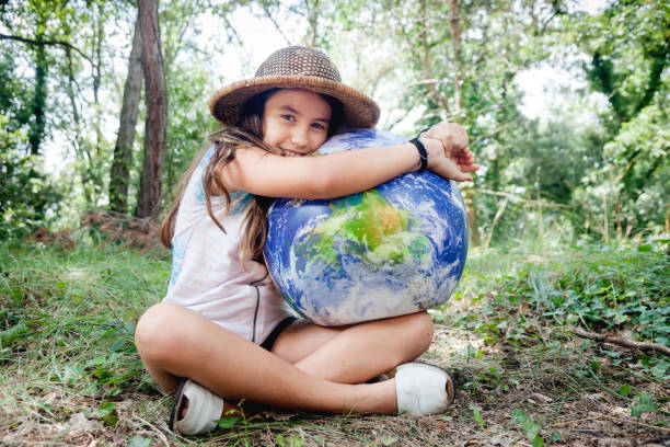 istock Little girl embracing world globe 1038239730