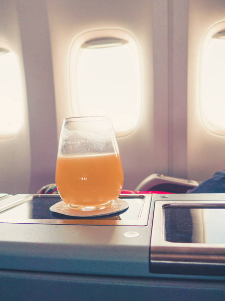 istock orange juice in business class flight, luxury travel 1038251544