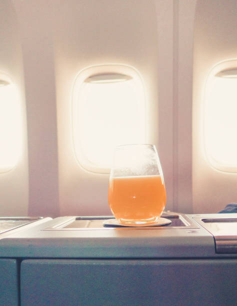 istock orange juice in business class flight, luxury travel 1038251572
