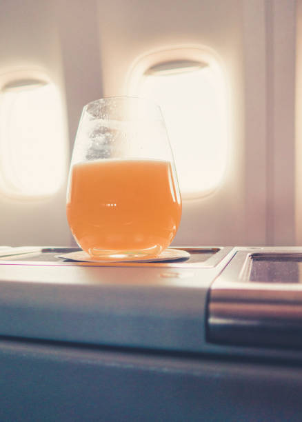 istock orange juice in business class flight, luxury travel 1038251634