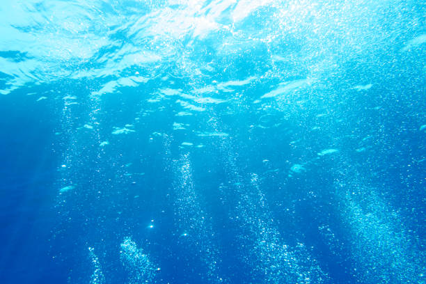istock Sunbeams and bubbles in the blue water 1038252924