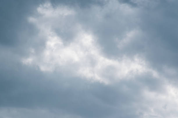 istock Blue sky with gray clouds.Bright blue sky with fluffy clouds in evening. 1038253026