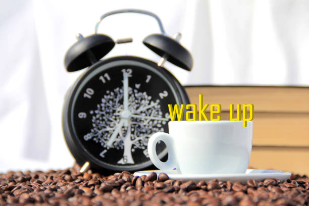 alarm clock, book, coffee cup and coffee beans