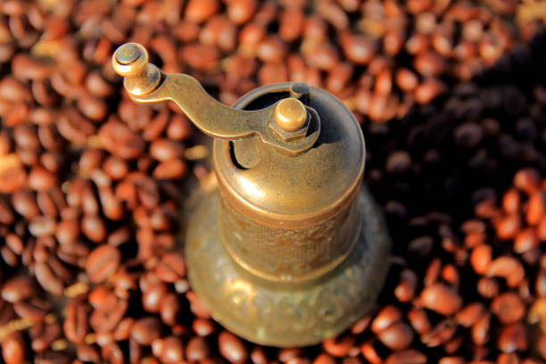 coffee beans and old copper coffee grinder