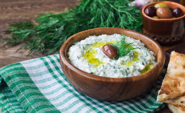 istock Tzatziki sauce in bowl on rustic wooden background 1038258098