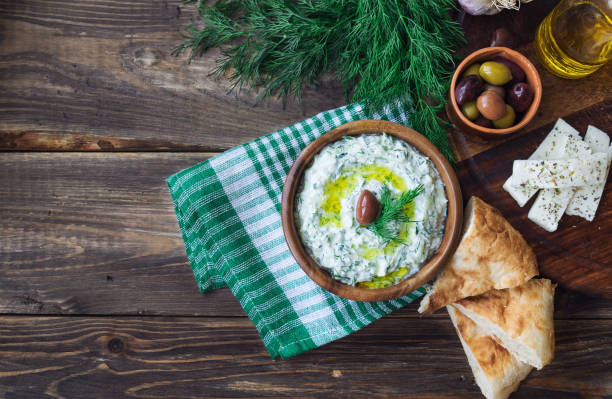 istock Tzatziki sauce in bowl on rustic wooden background 1038258112
