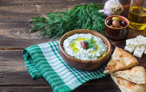 istock Tzatziki sauce in bowl on rustic wooden background 1038258158