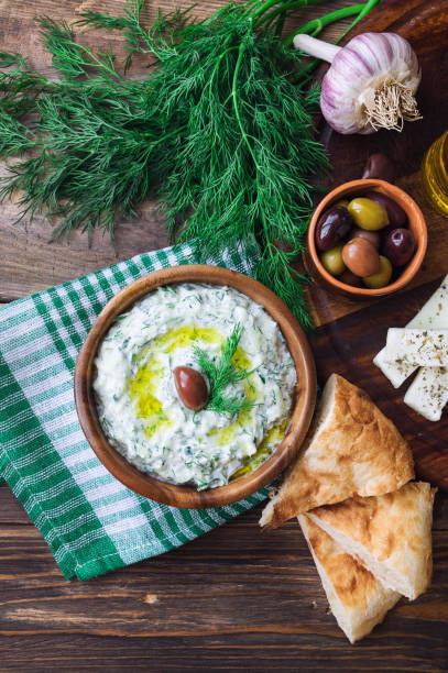 istock Tzatziki sauce in bowl on rustic wooden background 1038258180