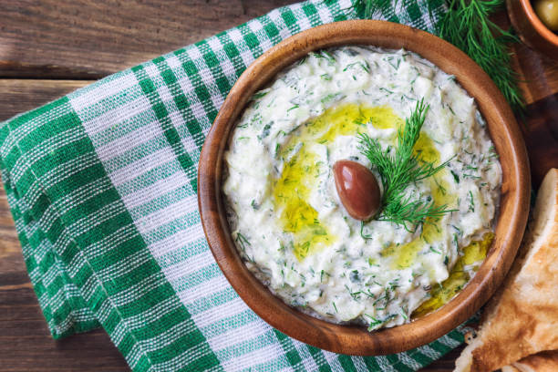 Tzatziki sauce in bowl on rustic wooden background Greek cuisine. Healthy vegetarian food. Top view. tzatziki stock pictures, royalty-free photos & images