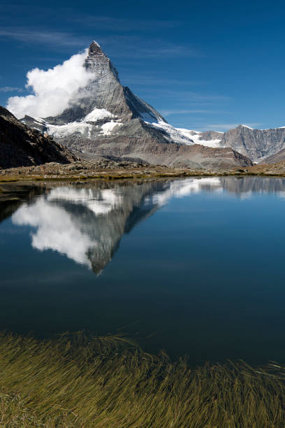 istock Riffelsee Lake with matterhorn reflections and clouds Vertical view 1038260654