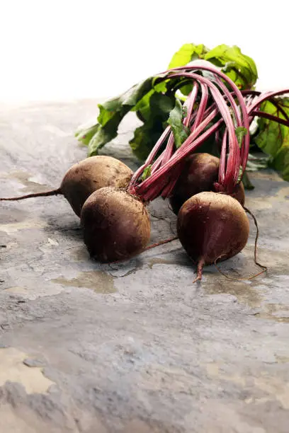 Red Beetroot with herbage green leaves on rustic background. Organic Beetroot.