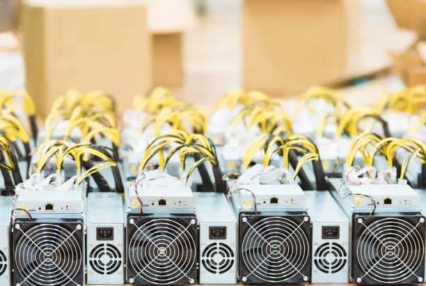 Photo of Rows of dedicated ASIC for cryptocurrency mining farm. Bitcoin, Ethereum and other altcoins producing rig.