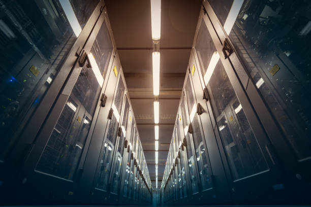 Abstract of modern high tech internet data center room with rows of racks with network and server hardware.
