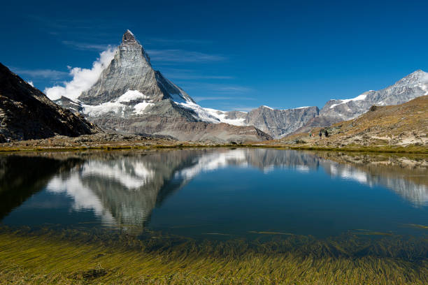 istock Riffelsee Lake with matterhorn reflections and clouds Horizontal view 1038268832
