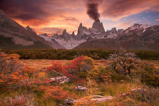 Spectacular sunset over fitzroy mountain with autmun colors and clouds looks like vulcano eruption Patagonia Argentina