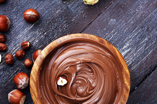 Homemade hazelnut spread in wooden bowl. Hazelnut Nougat cream.