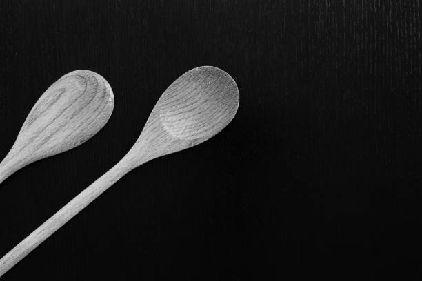 istock Wooden spoons on black table 1038291886