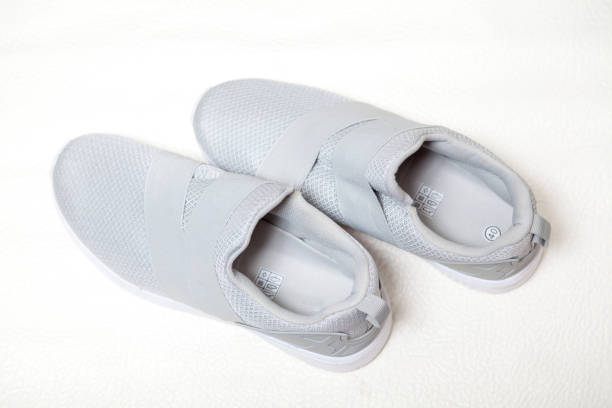 istock pair of gray sneakers stands on white background 1038292404