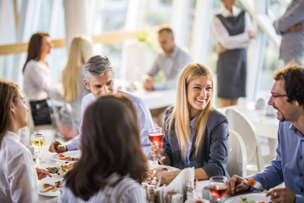 istock Group of happy business colleagues communicating while having lunch break in cafeteria. 1038296206