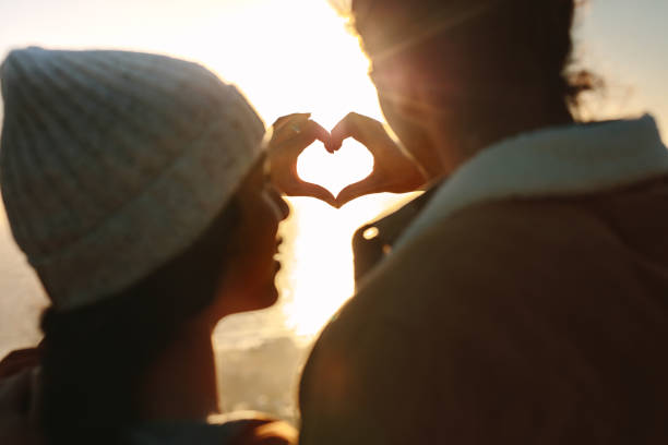 istock Romantic couple making heart with hands 1038304850