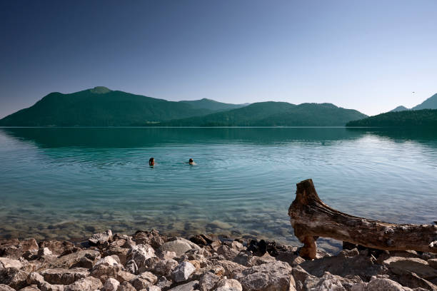 senior man and woman swimming in a mountain lake in Germany