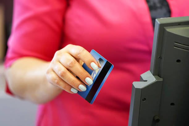 istock Swiping credit card in a reade 1038335586