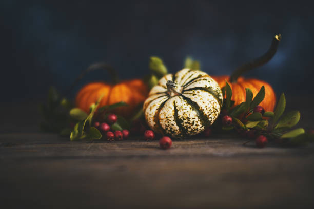 istock Artistic still life fall background with rustic wood and pumpkins 1038344128