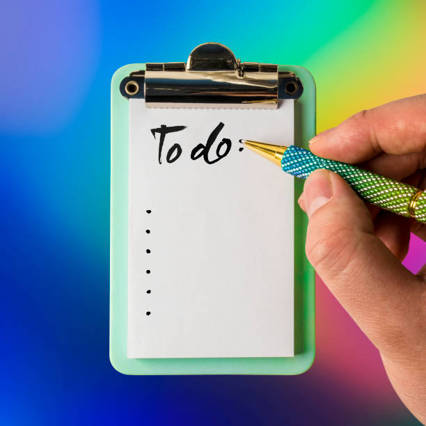 istock To do list with hand holding pen ready to write 1038349728