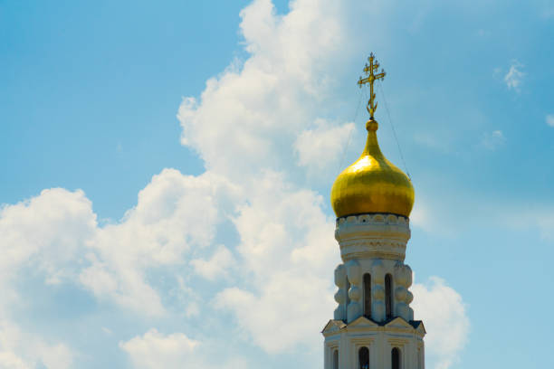 Dome with a cross on the Church against the sky.