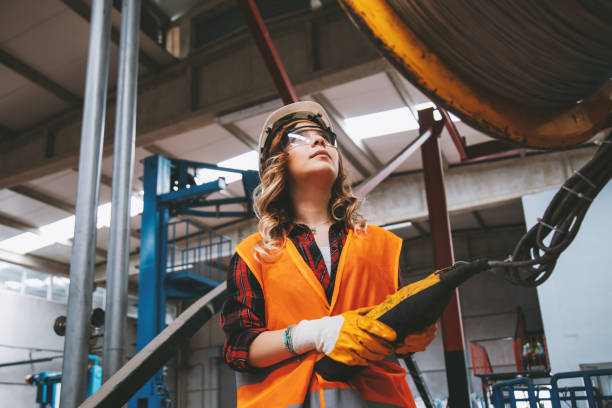 istock Young engineer woman holding and working with remote control for operating crane 1038364452