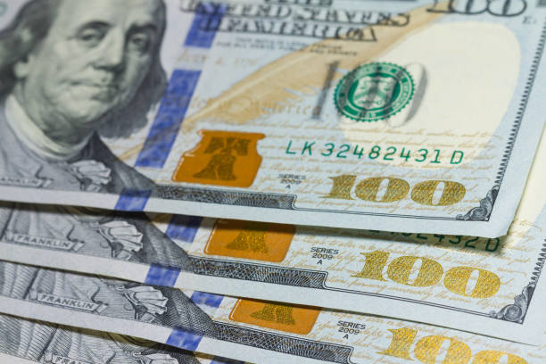 istock Stack of one hundred dollar banknotes close up with selective focus 1038369136