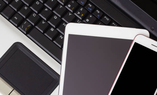 Smartphone and tablet on the laptop keyboard, business concept
