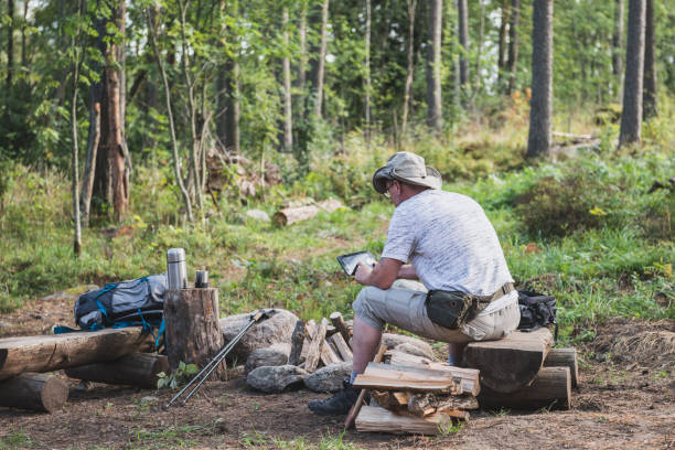 istock man in the forest by the fire plays in the tablet 1038373406