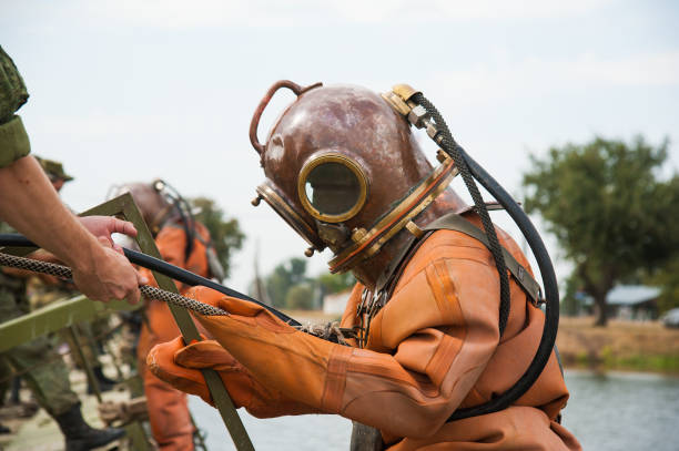 Diver immerses in a copper old vintage deep sea diving suit