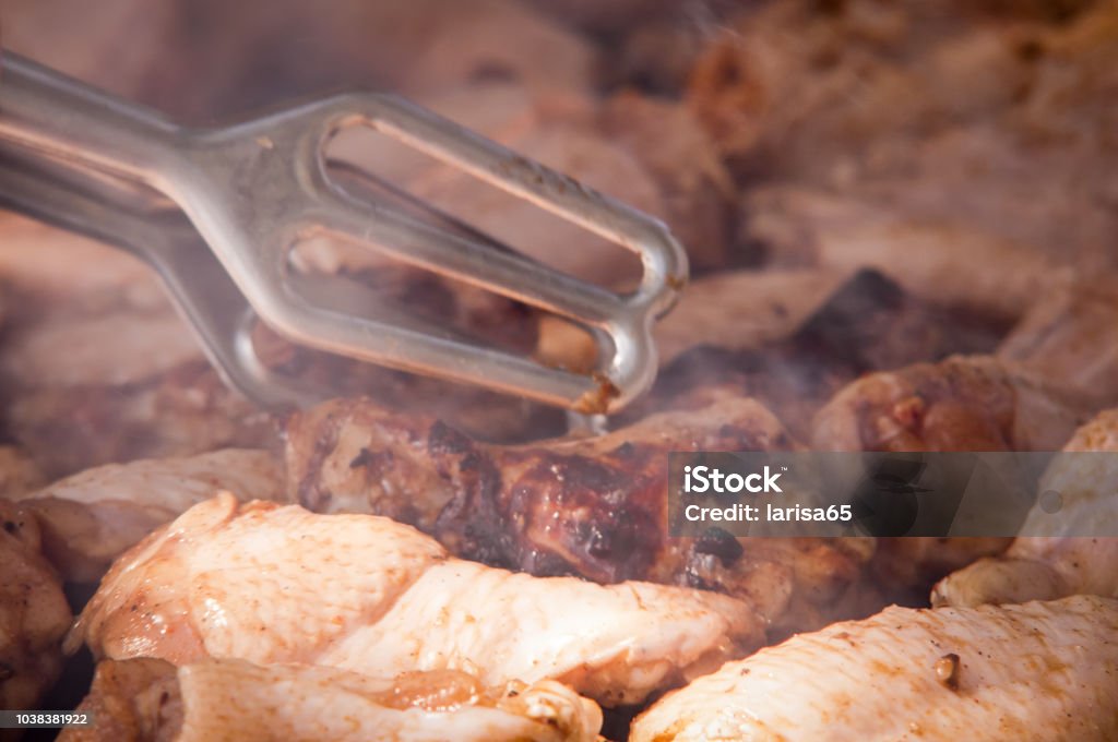 Grilled chicken legs on the grill . Grilled chicken thigh on the flaming grill . Appetizer Stock Photo