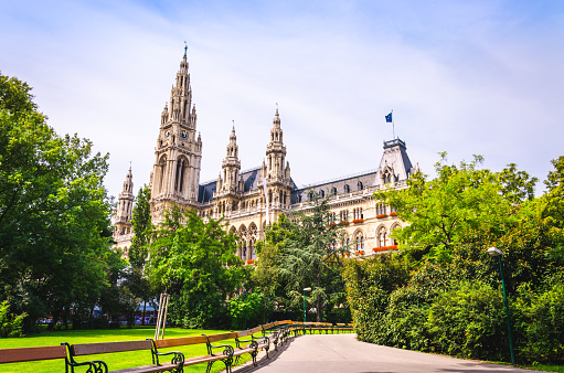 Facade of Vienna City Hall building, view from picturesque green park.