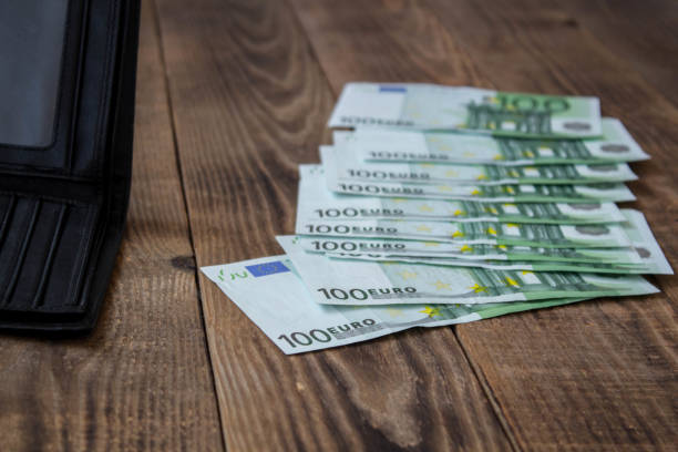 istock a wallet and money on a wooden background 1038385732
