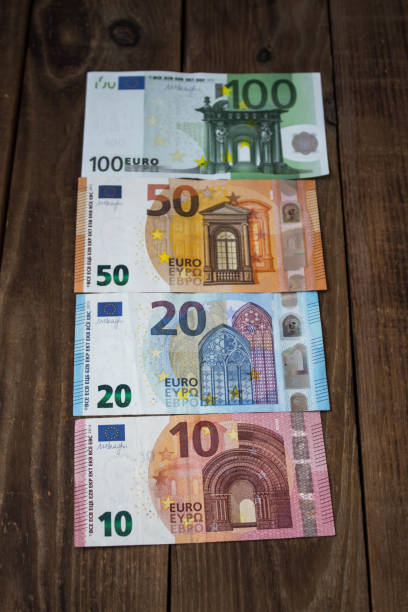 istock a euros bills on a wooden background 1038386058