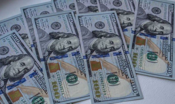 istock a one hundred dollars bills on white background 1038392234
