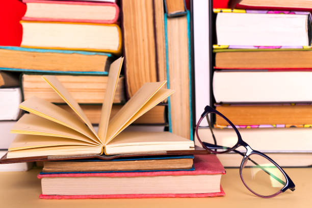 istock Open book, hardback books on bright colorful background. 1038393430