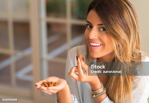 Young Beautiful Hispanic Woman At Home Stock Photo - Download Image Now - Almond, Eating, Women