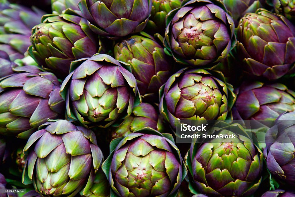 full frame of purple italian artichokes full frame of purple italian artichokes at the farmer's market Artichoke Stock Photo