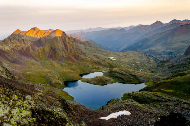 istock Panoramic View of Lake Amidst Mountains at Sunrise 1038395922