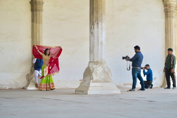 Agra/India - March 14, 2017: Cute engaged couple taking pictures in the fort Agra for their Indian wedding.
